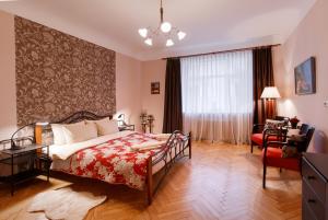 a bedroom with a bed and a chair and a window at ANNA Riga Apartment in Riga