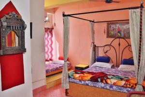 ジョードプルにあるGovind Hotelのピンクの壁のドミトリールーム ベッド2台