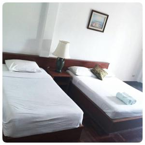 En eller flere senger på et rom på Malai-Asia Resort