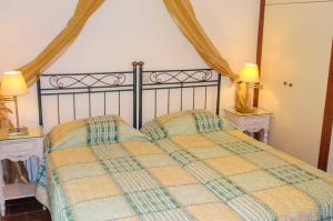 a bedroom with a bed with two tables and two lamps at Kerveli Luxury Villa in Kerveli