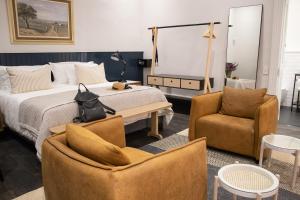 a bedroom with a bed and two chairs at Heritage House in Stellenbosch +184 photos