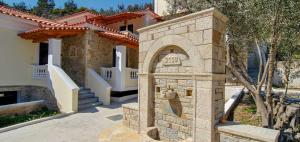 a stone archway in front of a house at Kerveli Luxury Villa in Kerveli