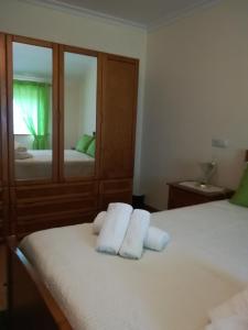 a bedroom with two beds and a mirror at Casa Serra da Lapa in Viseu
