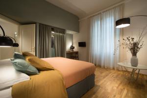 a bedroom with a bed and a table and a window at B&B Santa Maria del Fiore in Florence