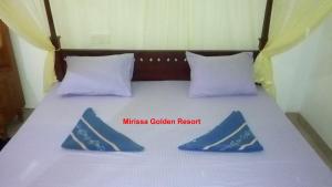Postel nebo postele na pokoji v ubytování Mirissa Golden Resort