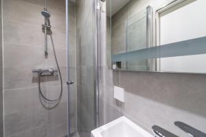 a bathroom with a shower and a sink and a mirror at Prinsengracht Canal Studios in Amsterdam +26 photos