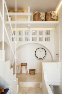 a white staircase in a room with white shelves at Calumàre in Polignano a Mare