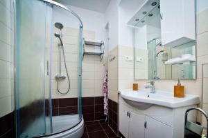 a bathroom with a glass shower and a sink at Split Apartments Peric in Split