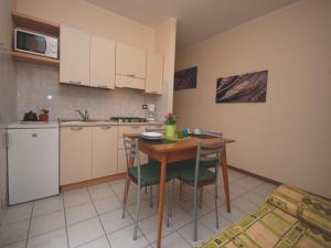 eine Küche mit einem Holztisch und Stühlen im Zimmer in der Unterkunft Villa Tiziano in Lignano Sabbiadoro
