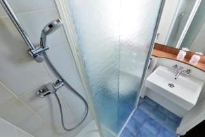a bathroom with a shower and a sink at Campanile Paris Ouest - Porte de Champerret Levallois in Levallois-Perret