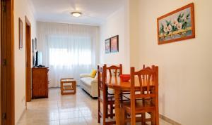 a dining room with a table and chairs and a couch at Duerming Bolera Pico in Portonovo