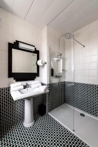 La salle de bains est pourvue d'un lavabo et d'une douche. dans l'établissement Best Western Hôtel Journel Paris Sud, à Ris-Orangis