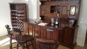 a wine cellar with a wooden bar with a bottle of wine at Ferienhaus Boedefelder in Winterberg
