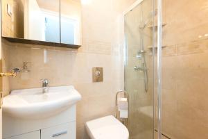 a bathroom with a sink toilet and a shower at House Glasnović in Cavtat +14 photos