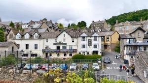 a town with cars parked in a parking lot at The Commodore Inn in Grange Over Sands