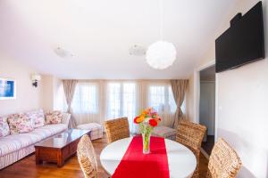 a living room with a table and chairs and a couch at House Glasnović in Cavtat