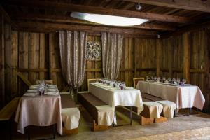 a dining room with two tables with white table cloth at Irvese Puhkemaja in Haanja
