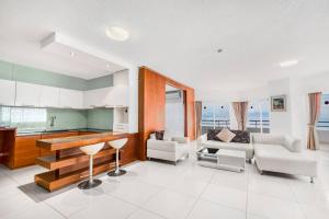a living room with a couch and a table at Markland Seaside Pattaya in Pattaya