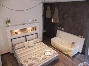 - une chambre avec un lit et une baignoire dans l'établissement Gea Apartment Etna, à Nicolosi