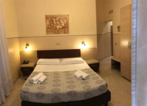 ローマにあるBel soggiornoのベッドルーム1室(ベッド1台、タオル2枚付)