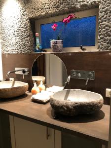 une salle de bains avec deux lavabos sur un comptoir dans l'établissement Luxe vakantiehuis in het bos, à Overbroek