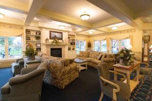 a large living room with couches and a fireplace at Essenhaus Inn & Conf. Center in Middlebury
