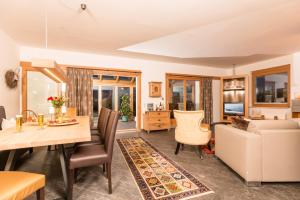 a living room with a dining table and a couch at Villa Heimatliebe in Ramsau im Zillertal