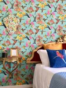 a bedroom with a blue wall with a floral wallpaper at Palazzina300 in Treviso