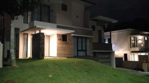 a house at night with a lawn in front of it at SleepRest @ Nagoya Valley in Nagoya