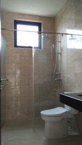 a bathroom with a glass shower with a toilet at SleepRest @ Nagoya Valley in Nagoya
