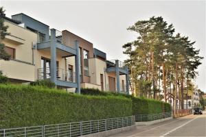 a building with balconies on the side of a street at Apartamenty Gabrysia 8 in Międzywodzie