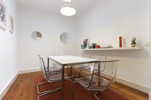 a dining room with a table and four chairs at Chiado Views by Homing in Lisbon