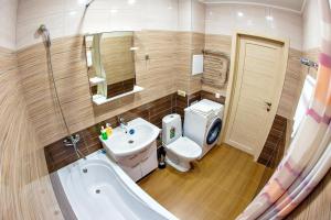 a bathroom with a sink and a toilet and a tub at SutkiUfa Рихарда Зорге 67/2 in Ufa