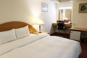 Una cama o camas en una habitación de Oriental Hotel
