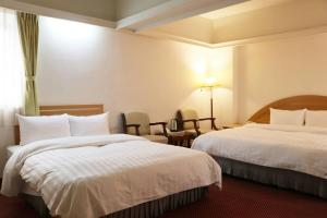 Oriental Hotel tesisinde bir odada yatak veya yataklar