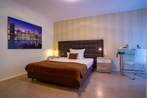 Cama ou camas em um quarto em Villa Westend Hotel an der Messe