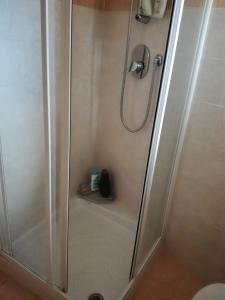 a shower in a bathroom with a glass door at Casa Gemma in Diano Marina