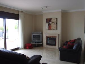 salon z kominkiem i telewizorem w obiekcie 2 Bedroom Apartments on Private Gated Development w mieście Mijas