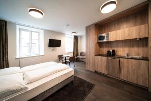 a hotel room with a bed and a sink at Blackhome Innsbruck Boutique I contactless check-in in Innsbruck