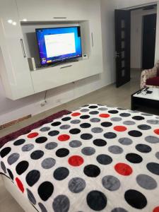 sypialnia z łóżkiem z kocem z kropką polki w obiekcie Ana Studio Apartment w mieście Gałacz