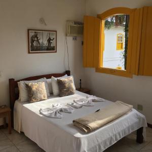 Säng eller sängar i ett rum på Pousada Fortaleza