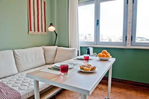 a living room with a table and a couch at Champagne Shower Apartment 5C in Lisbon
