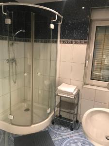a bathroom with a glass shower and a sink at Dom Sówka in Radzyń +19 photos