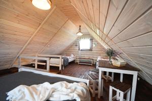 a bedroom in a log cabin with a bed at klub Karino 2 in Mikołajki