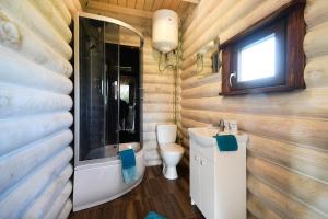 a bathroom with a sink and a toilet and a window at klub Karino 2 in Mikołajki +36 photos