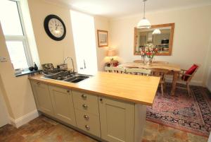 a kitchen and dining room with a sink and a table at Pip's Corner in Lynton