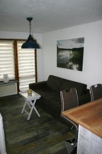 a living room with a couch and a table at Ferienwohnung Am See 55 in Bad Saarow