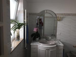 a person taking a picture of a bathroom with a sink at La Ninfa Di Capri in Anacapri