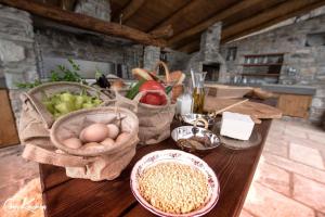 a table with baskets of food and eggs on it at Gastronomy Hotel Kritsa in Portaria