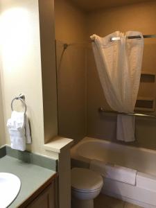 a bathroom with a tub and a toilet and a sink at Elkhorn Village in Sun Valley